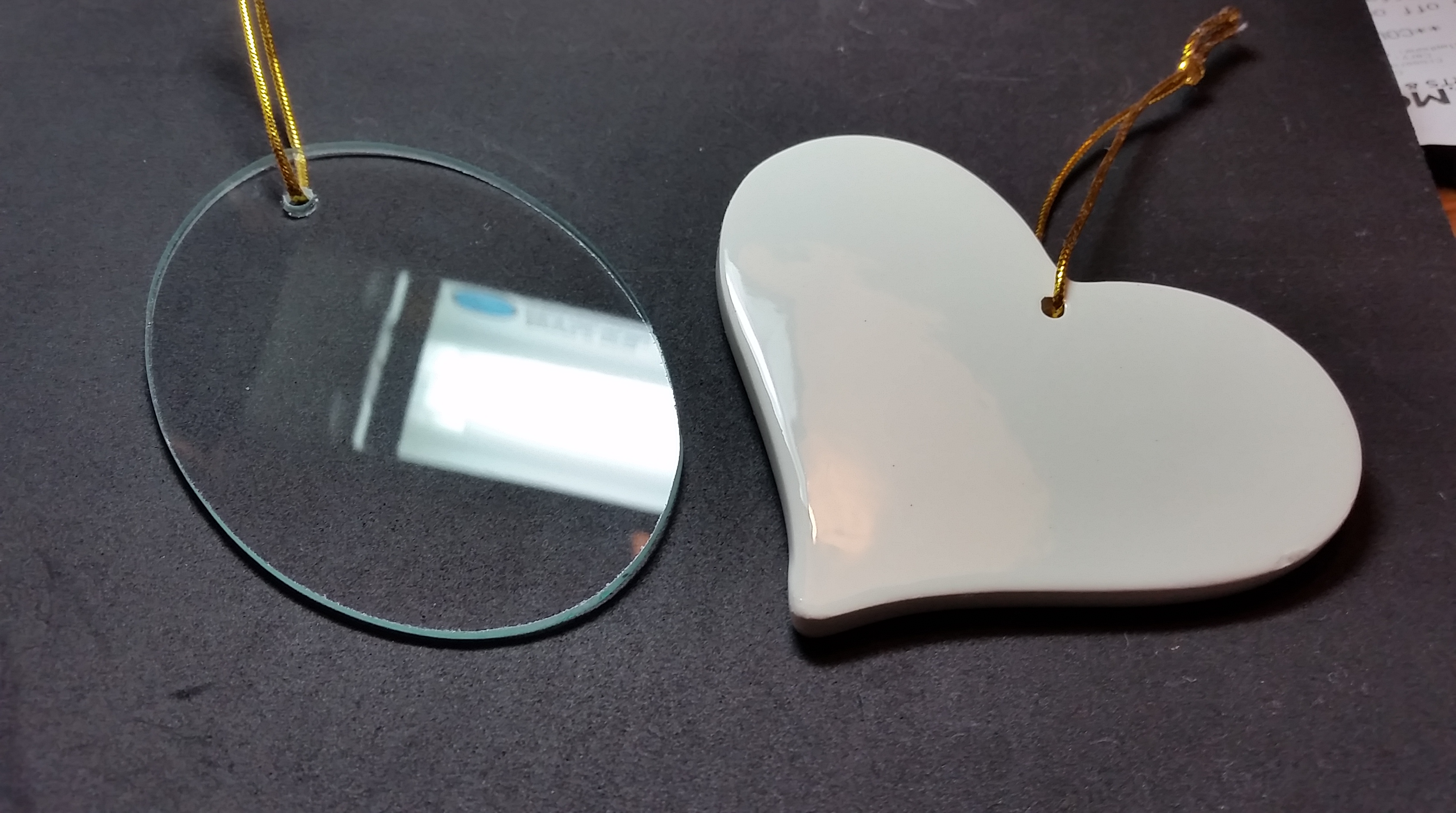 The two blank Christmas ornaments. On the left is the glass on (and the reflection of the Ott light is intentional, to show the surface texture), on the right is a ceramic heart.